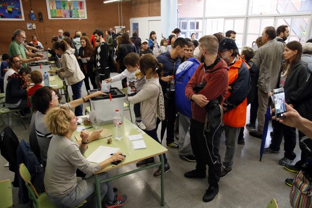 Voters crowd the room at a polling station