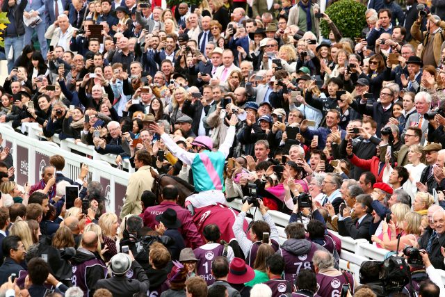 Frankie Dettori salutes the packed crowd at Chantilly