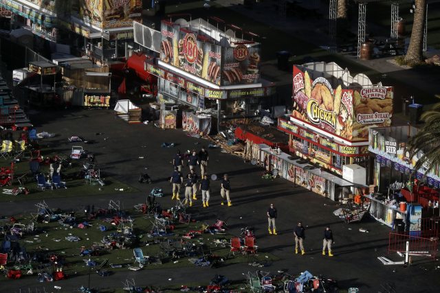 Investigators work at a festival grounds across the street from the Mandalay Bay Resort and Casino  (Marcio Jose Sanchez/AP)