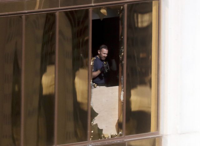 An investigator works in the room at the Mandalay Bay Resort and Casino in Las Vegas 