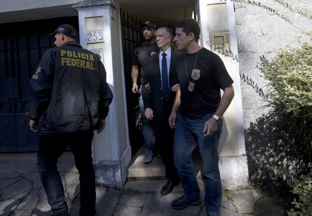 Carlos Nuzman (centre) is escorted by federal police officers after being taken into custody at his home (Silvia Izquierdo/AP)