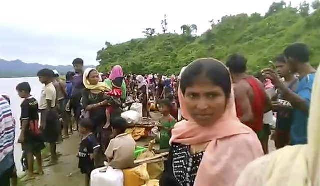 Villagers cross a river near the border with Bangladesh (Arakan Rohingya National Organization via the AP)