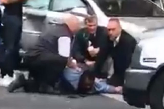 Screen grab of man being detained outside the Natural History Museum in London