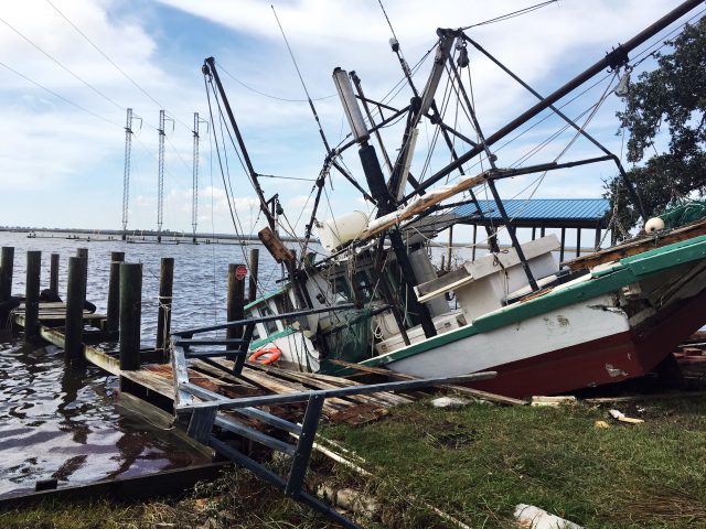 A shrimp boat is sunk at its mooring along the Pascagoula River in Moss Point, Mississippi