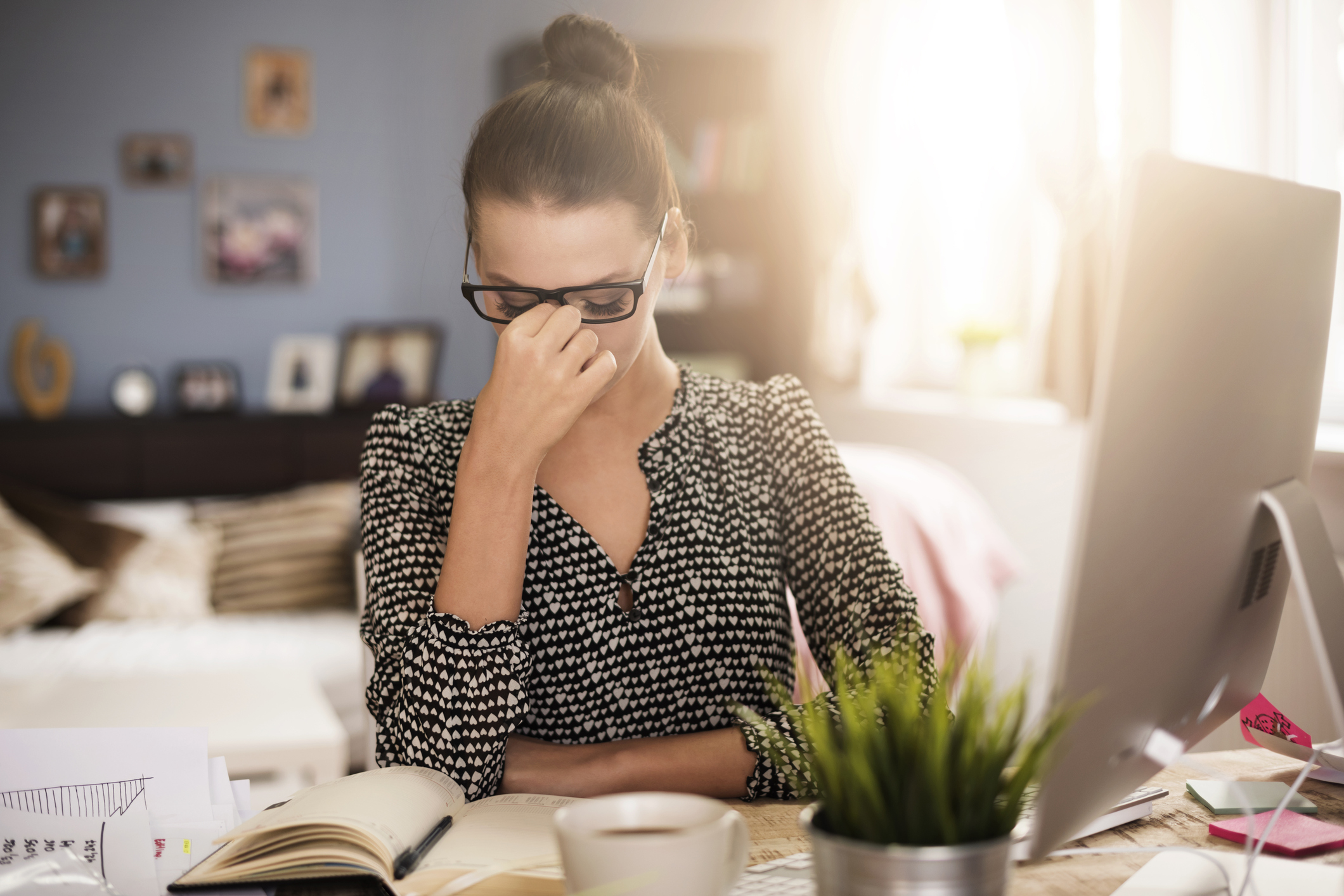 Generic photo of woman at a desk rubbing her eyes (Thinkstock/PA)