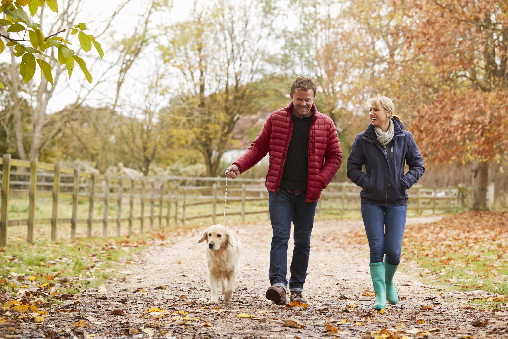 Couple walking with their dog (Thinkstock/PA)