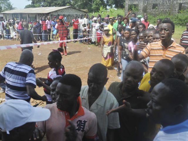 People wait to cast their votes in Monrovia