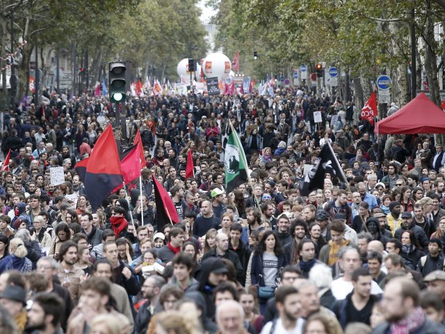 Demonstrators march to protest against President Emmanuel Macron's economic policies in Paris