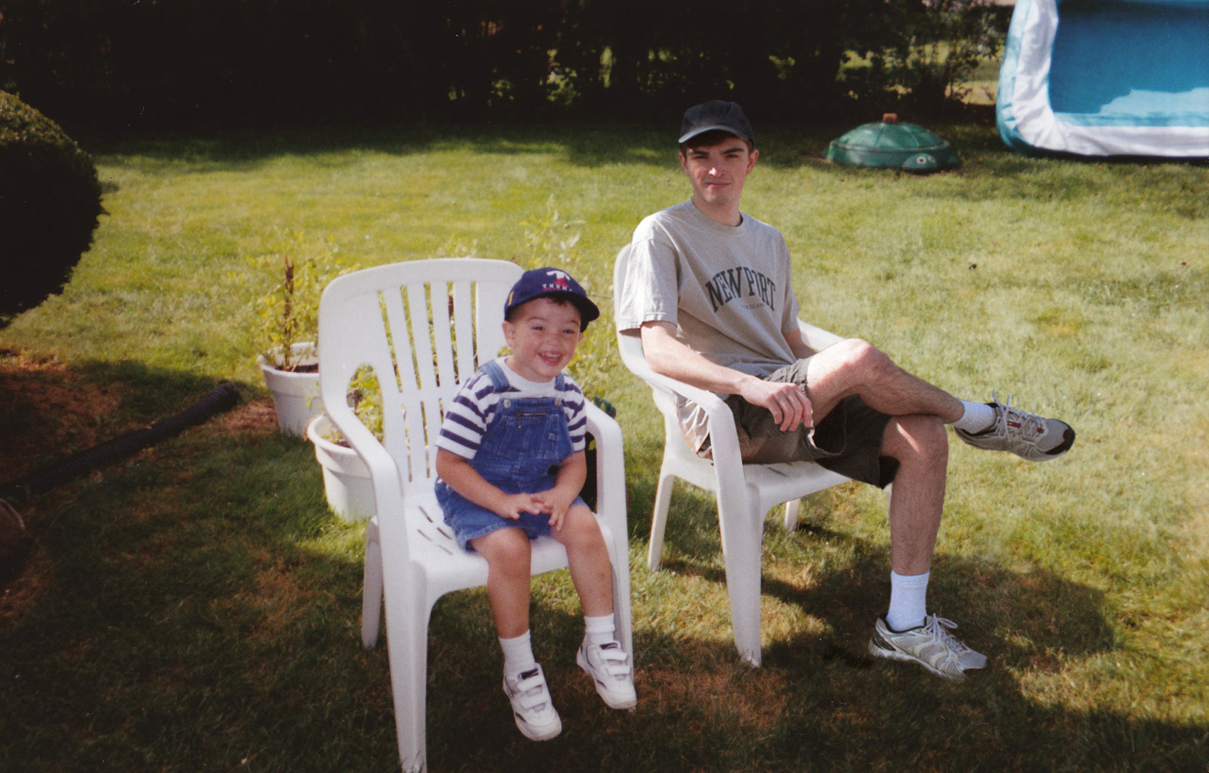 Conor and his younger self on chairs outside
