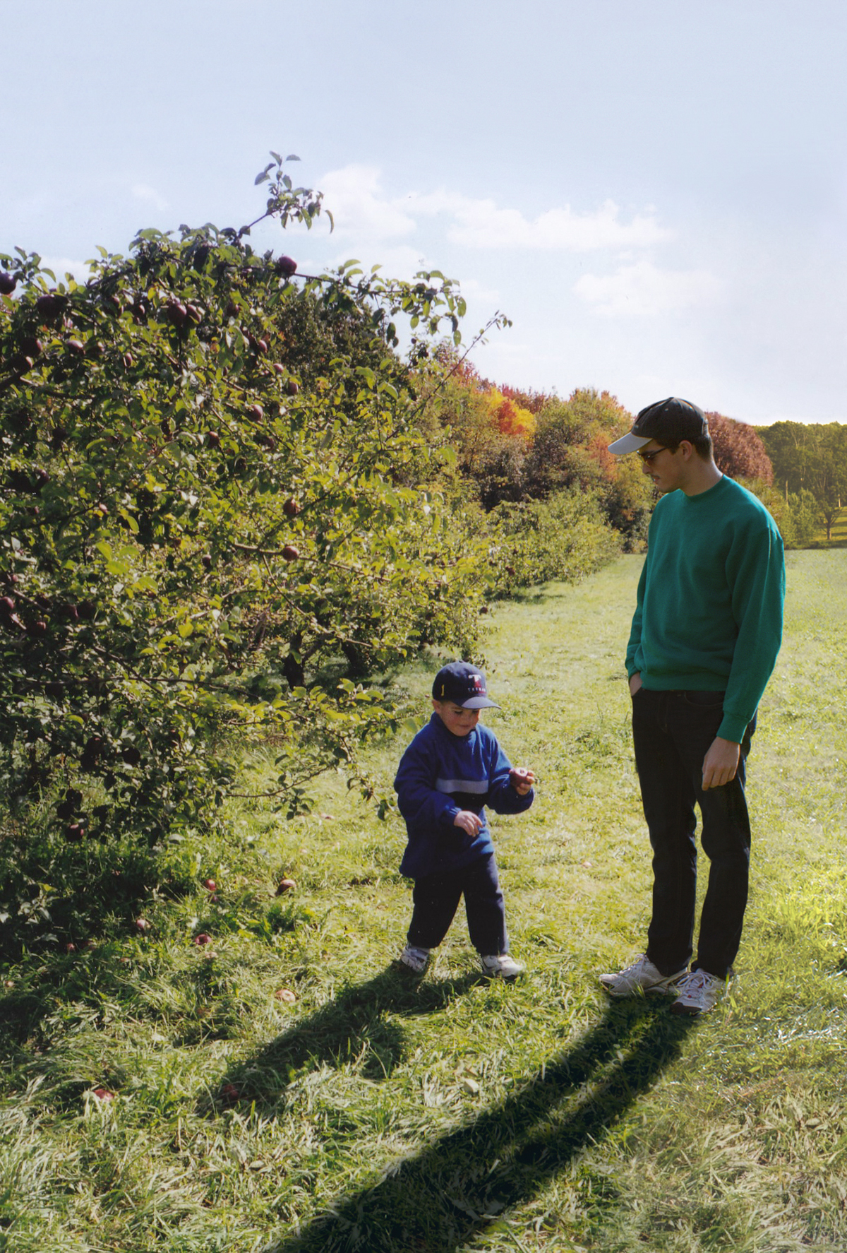 Conor and his younger self in an orchard
