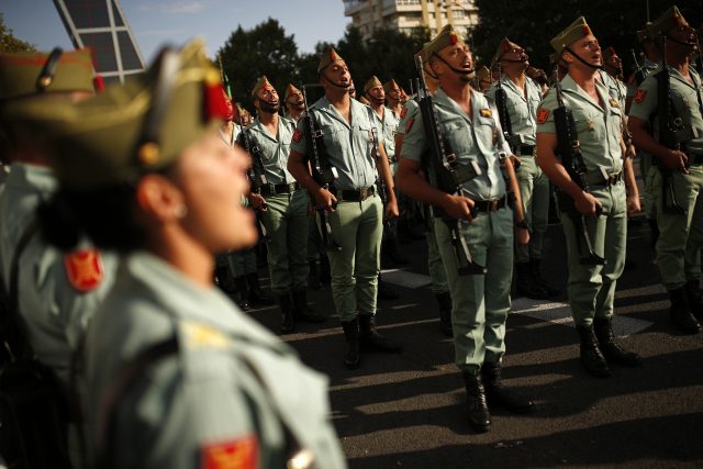 Spanish military personnel march in a military parade in Madrid