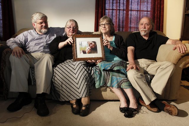 Patrick Boyle, Linda Boyle, Lyn Coleman and Jim Coleman hold a photo of their kidnapped children