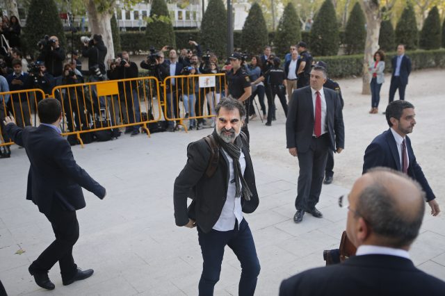 Jordi Cuixart, president of the Catalan Omnium Cultural organization, center, smiles on arrival at the national court in Madrid