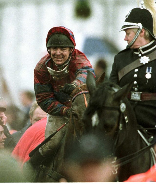 A mud-splattered Richard Guest wins the Grand National in 2001. He has a nice horse on his hands in Lough Salt