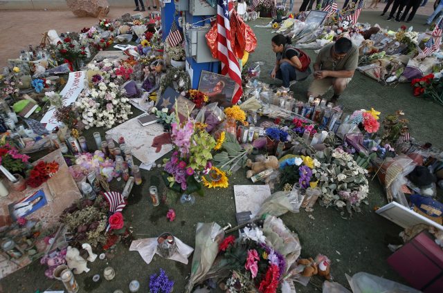 People visit a makeshift memorial for victims of the mass shooting in Las Vegas