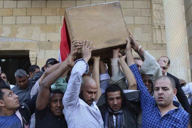 People carry the coffin of police captain Ahmed Fayez, who was killed in a gun battle in al-Wahat al-Bahriya area in Giza province, during his funeral at Al-Hosary mosque in Cairo