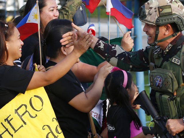 Families welcome home armed forces at Villamor Air Base, south-east of Manila 