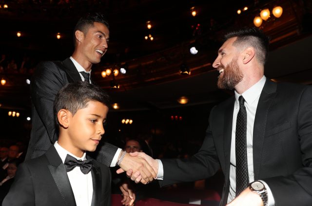 Cristiano Ronaldo Snr and Jr shake hands with Lionel Mess