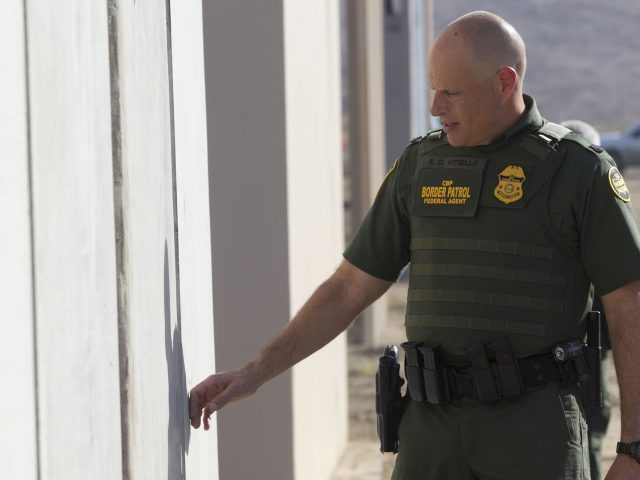 Ronald Vitiello of US Customs and Border Protection examines  a sample wall