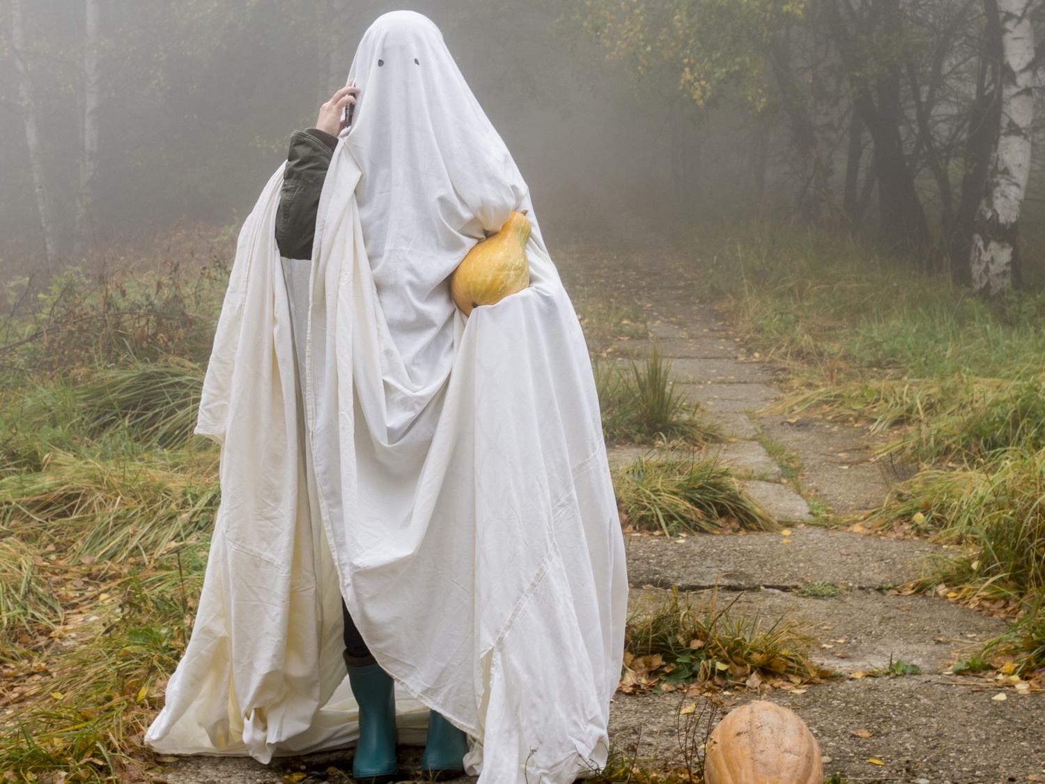Generic photo of woman wearing white sheets to look like a ghost (Thinkstock/PA)