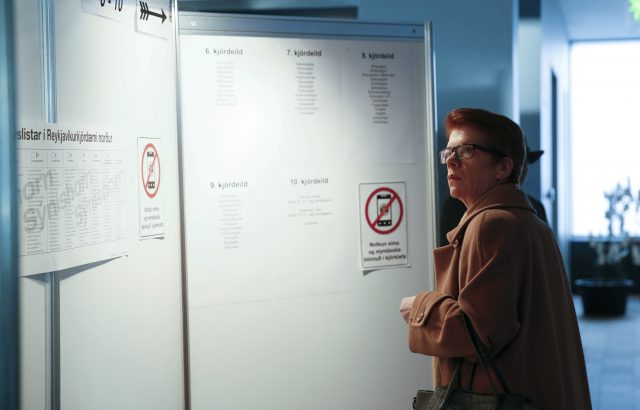 A voter checks a board on where to vote, at the Reykjavik City Hall polling station