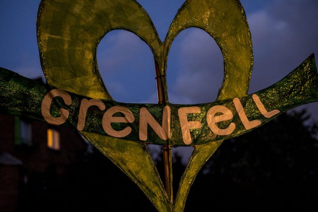 A banner during a silent march for Grenfell Tower fire victims in west London