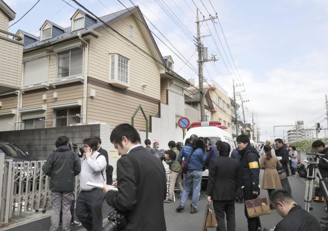 People gather in front of the apartment where police found dismembered bodies 