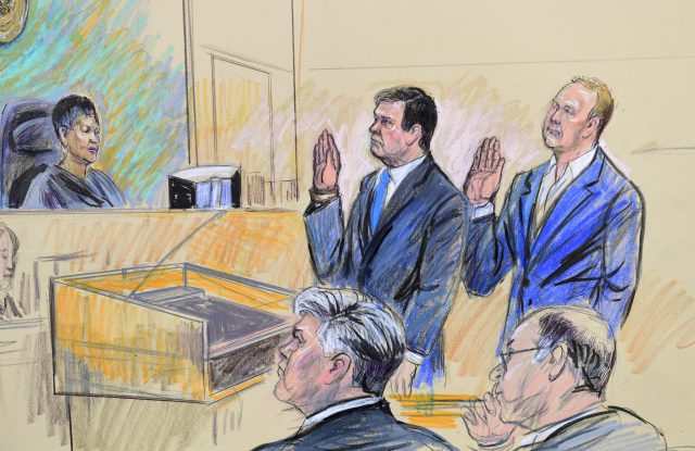 Paul Manafort, centre standing and Manafort's business associate, Rick Gates, in federal court in Washington