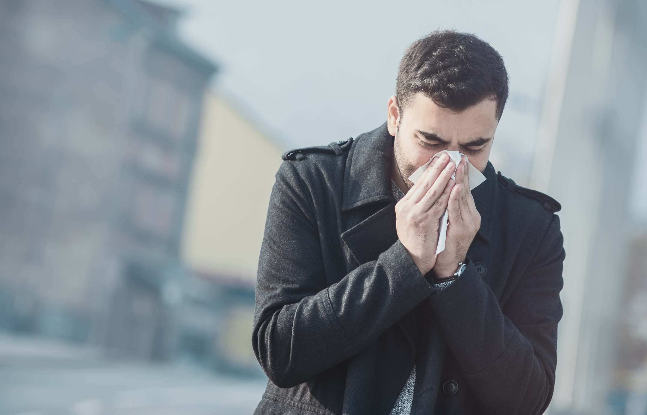 Man blows his nose 