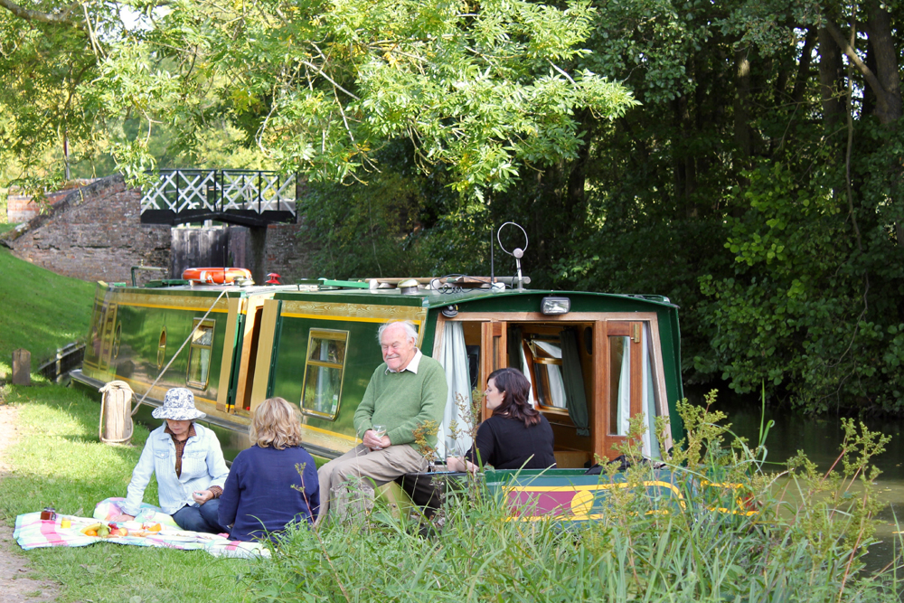 Family picnic at the water's edge. (Timothy West/PA)