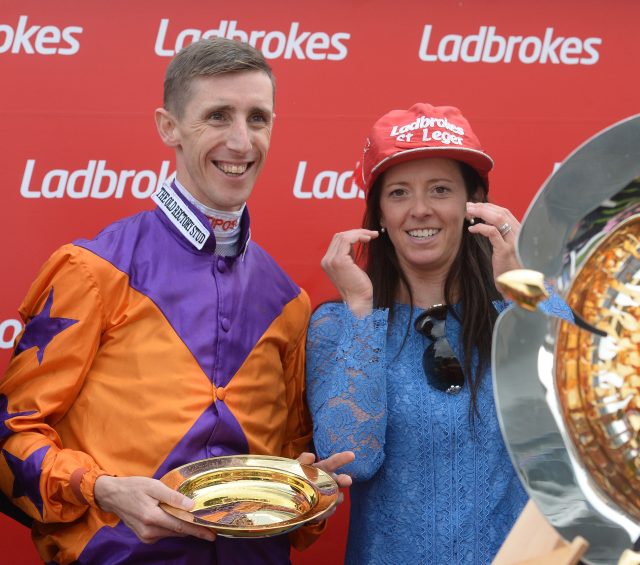 George Baker and trainer Laura Mongan celebrate after their victory with Harbour Law in the Leger