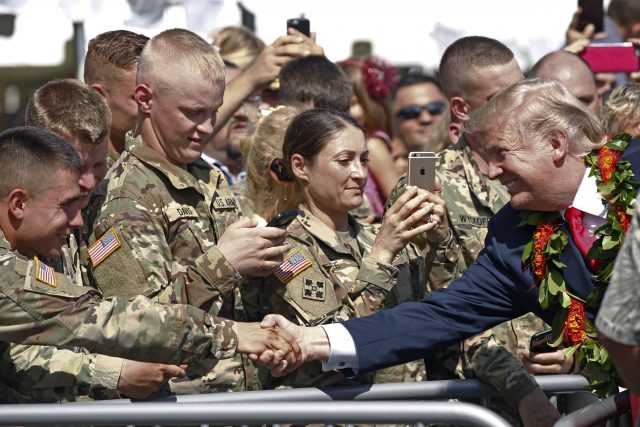 Donald Trump greets servicemen after arriving at Joint Base Pearl Harbour Hickam in Honolulu