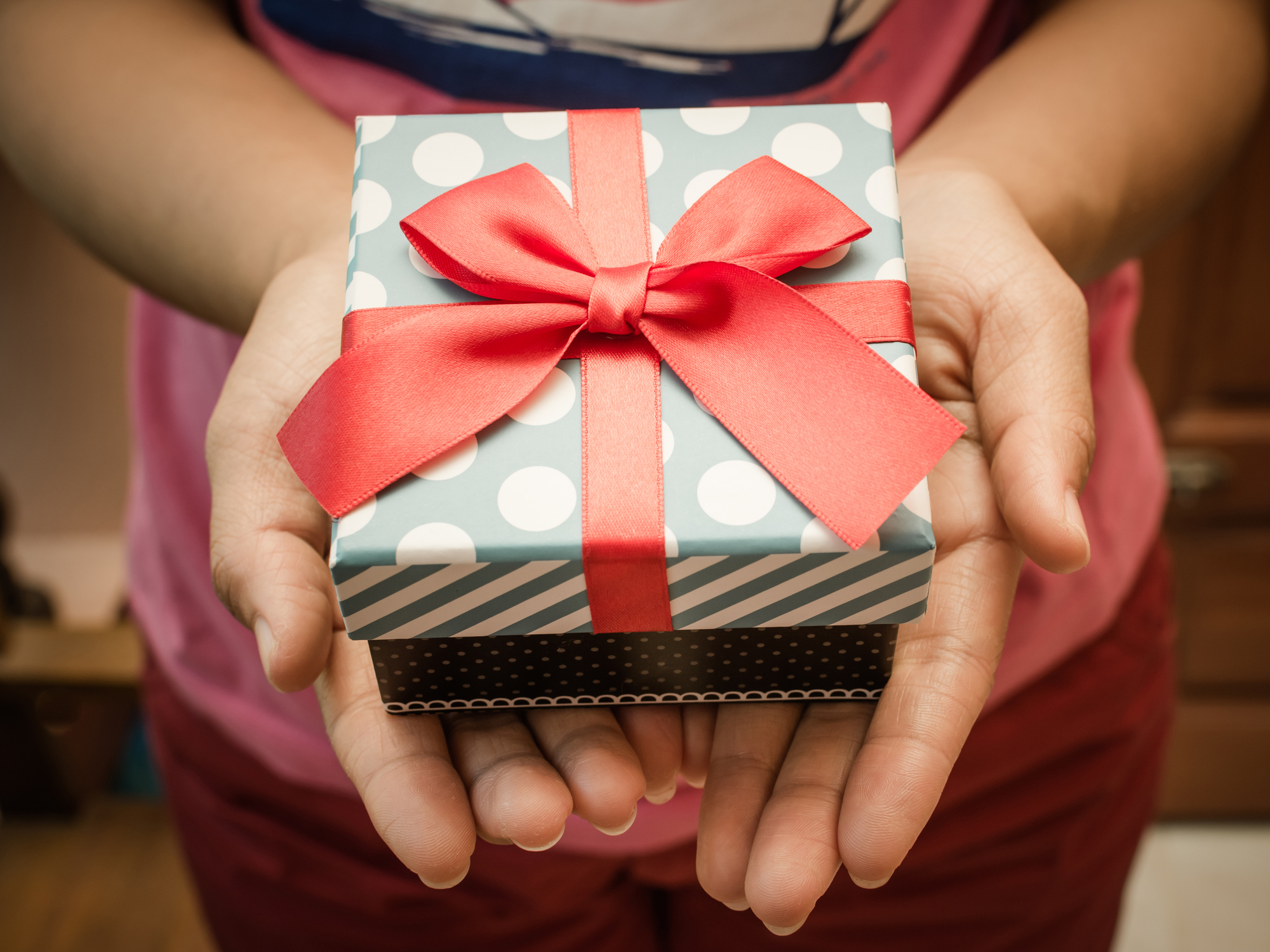 Woman holds a wrapped gift