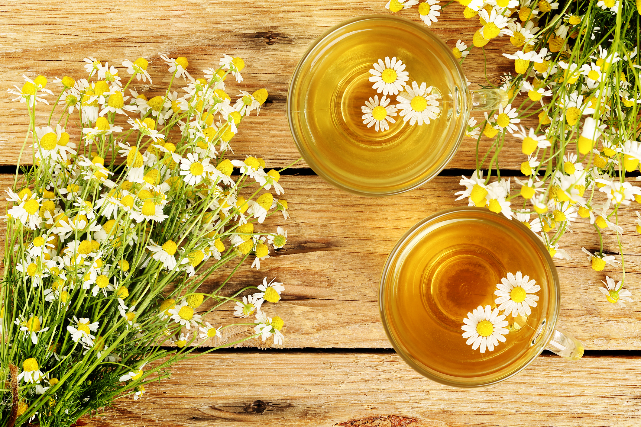 cups of chamomile tea with chamomile flowers on wooden planks (Thinkstock/PA)