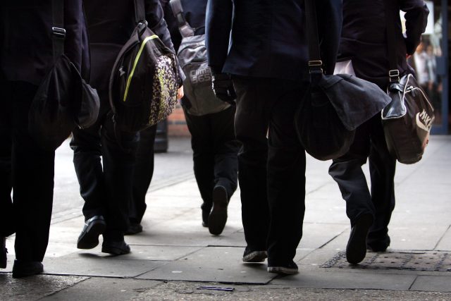 Having more girls in the classroom could help boost boys' results (PA)