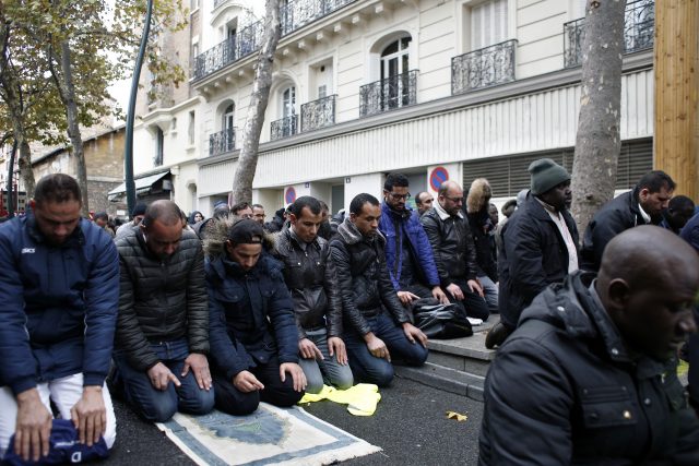 Muslims pray in the street in the Paris suburb of Clichy la Garenne