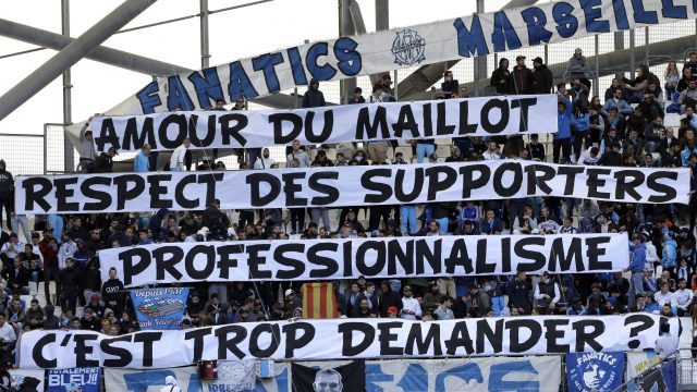 Marseille supporters display banners reading