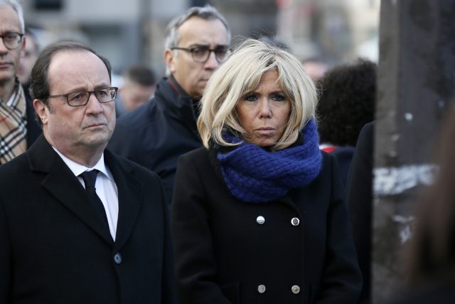 Emmanuel Macron's wife Brigitte and former French President Francois Hollande stand at a memorial (Etienne Laurent, Pool via AP)