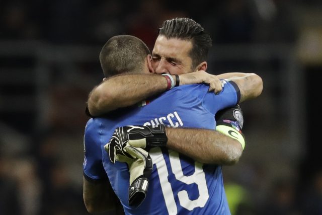 Gianluigi Buffon is comforted by his team-mate