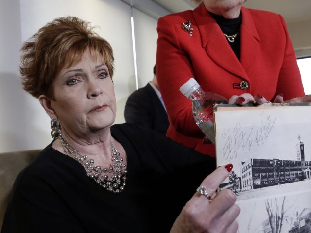 Beverly Young Nelson with her high school yearbook signed by Roy Moore