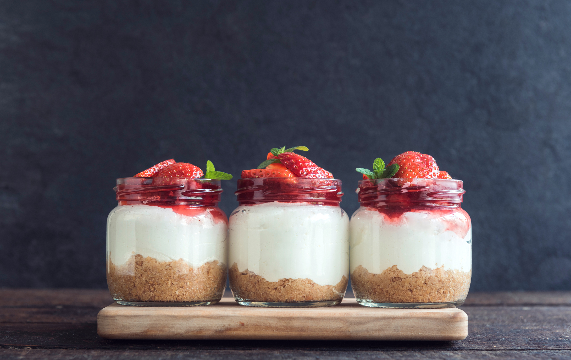 Sweet homemade cheesecake with strawberries in the jar on wooden background (Thinkstock/PA)
