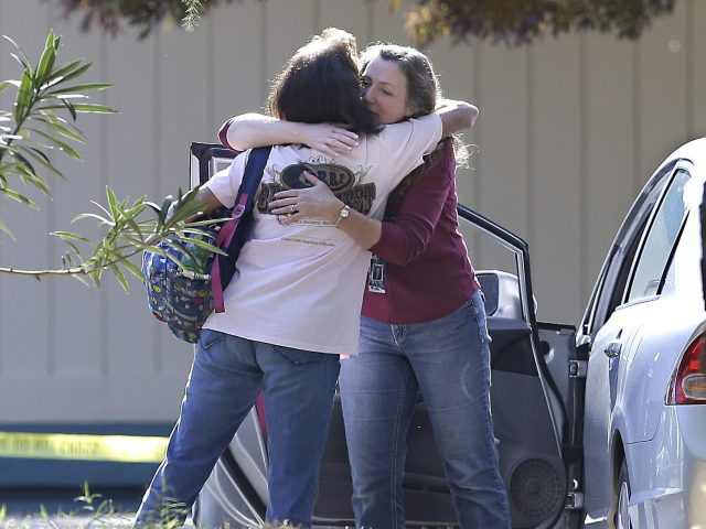Women embrace outside Rancho Tehama Elementary School