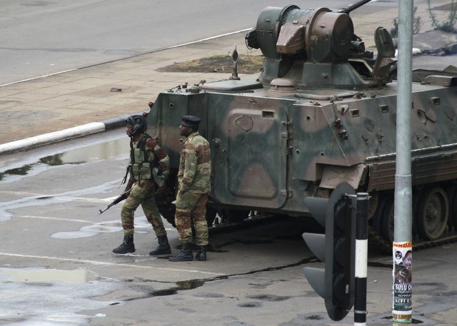 A military tank is seen with armed soldiers on the road leading to President Robert Mugabe's office in Harare