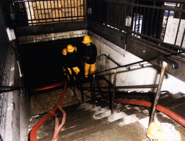 Firemen attend the scene of the fire-damaged King's Cross Underground Station 