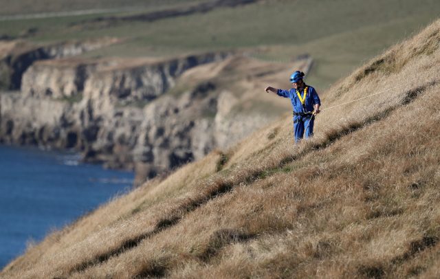 Search and rescue teams perform a search on the cliffs above the coast near to Swanage