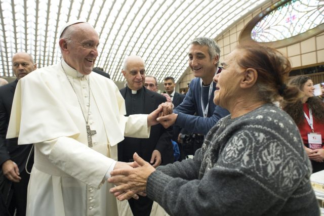 Pope Francis greets his hosts during a lunch at the Vatican. (AP)