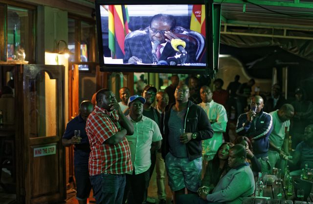 Disappointed Zimbabweans watch the televised address. (Ben Curtis/AP)