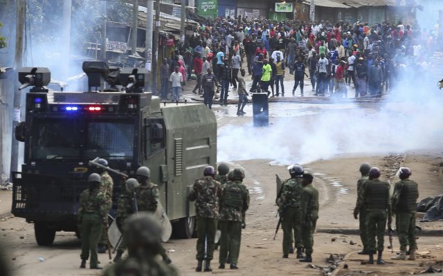 Supporters of opposition leader Raila Odinga face riot police during running battles with police in Kibera Slums in Nairobi