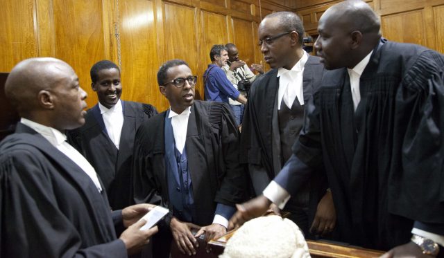 Ahmednasir Abdullahi, left, lawyer for Uhuru Kenyatta, and his team celebrate during the judgment of the petitions