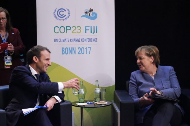 German Chancellor Angela Merkel, right, talks to French president Emmanuel Macron during the 23rd Conference of the Parties (COP) climate talks in Bonn, Germany